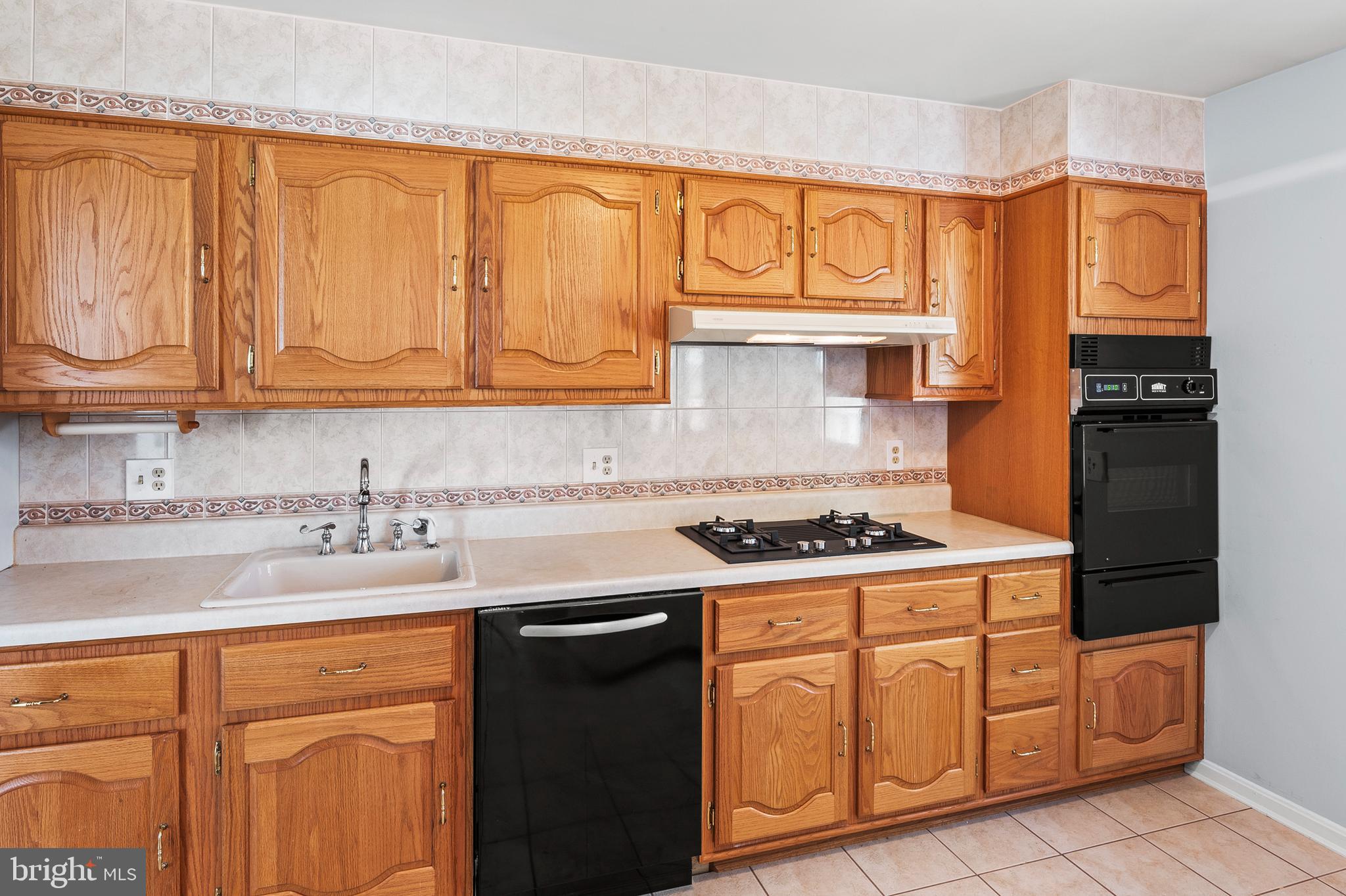 1904 Powder Mill Road Silver Spring, MD 20903 - Photo 9 of 43 a kitchen with stainless steel appliances granite countertop a stove a sink and dishwasher with white cabinets
