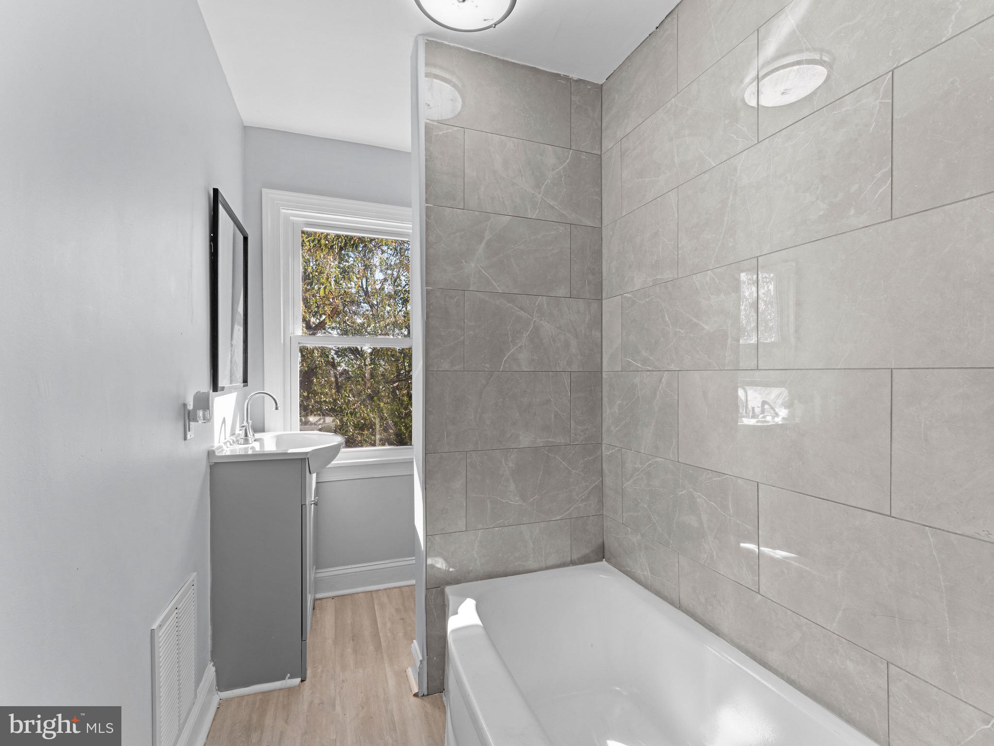 125 White Avenue Marcus Hook, PA 19061 - Photo 17 of 23 a bathroom with a bathtub and shower