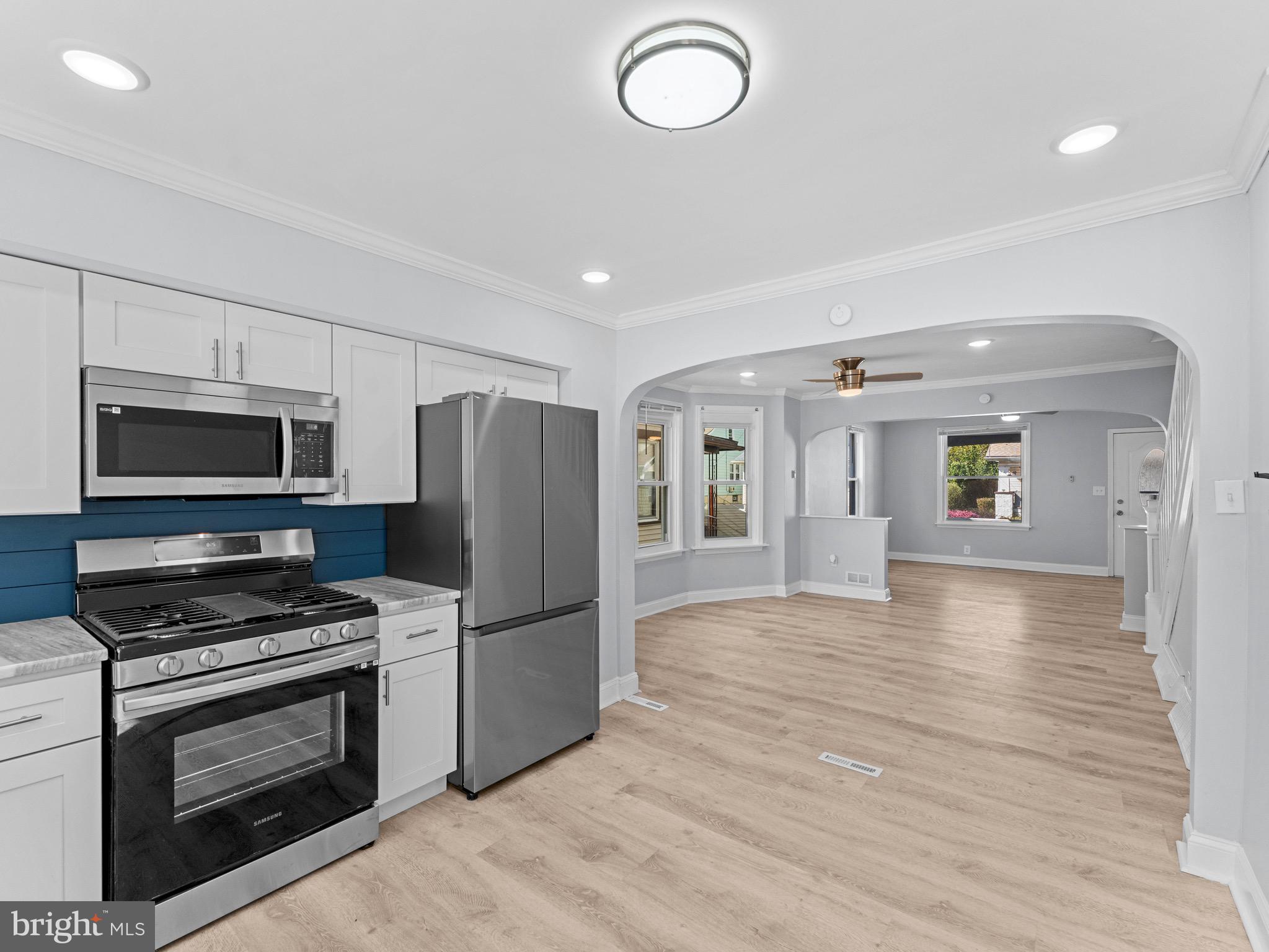 125 White Avenue Marcus Hook, PA 19061 - Photo 10 of 23 a kitchen with granite countertop a refrigerator stove and microwave