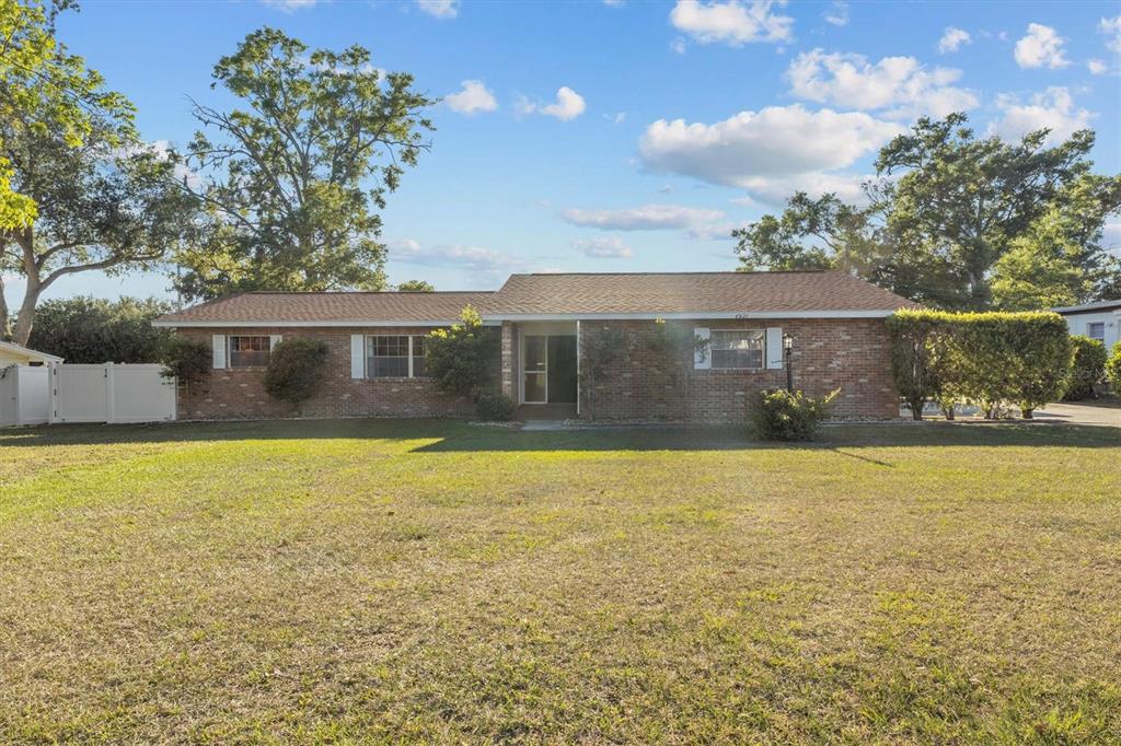 a view of house with outdoor space and yard