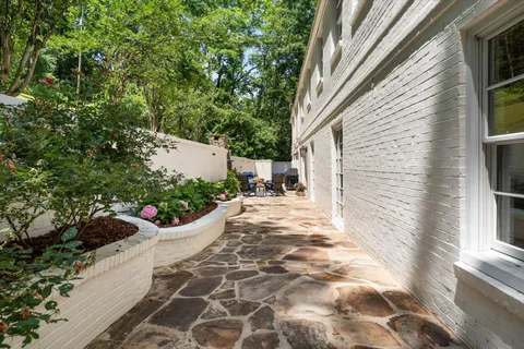 a view of a white house with a yard and plants