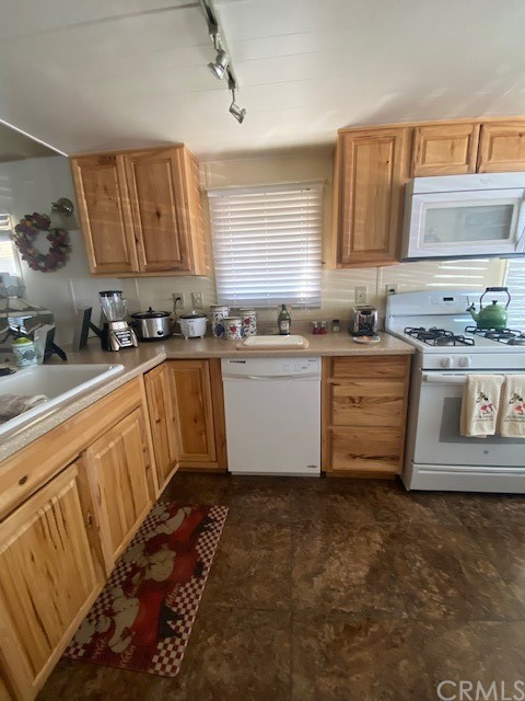 12874 California Street, Unit 48 Yucaipa, CA 92399 - Photo 12 of 21 a kitchen with granite countertop a sink stove and cabinets