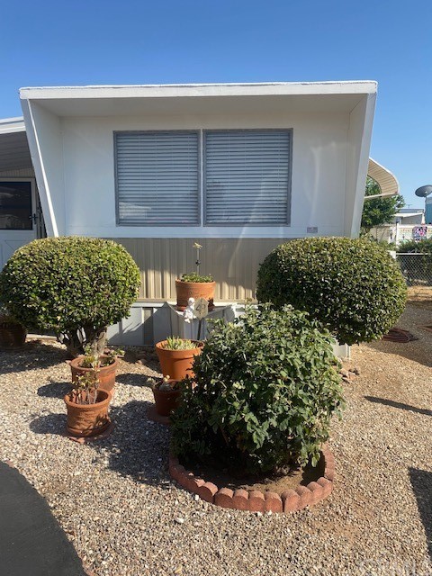 12874 California Street, Unit 48 Yucaipa, CA 92399 - Photo 18 of 21 a front view of a house with a yard