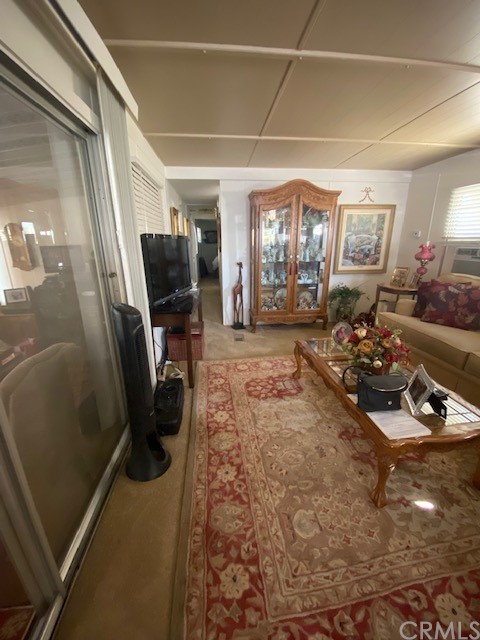12874 California Street, Unit 48 Yucaipa, CA 92399 - Photo 20 of 21 a room with furniture a window and gym equipment