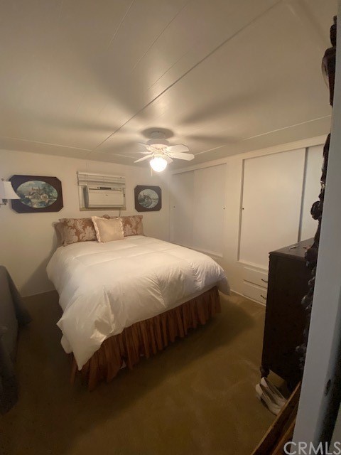 12874 California Street, Unit 48 Yucaipa, CA 92399 - Photo 2 of 21 a bedroom with a bed and chair