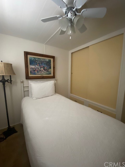 12874 California Street, Unit 48 Yucaipa, CA 92399 - Photo 4 of 21 a bedroom with a large bed and a chandelier