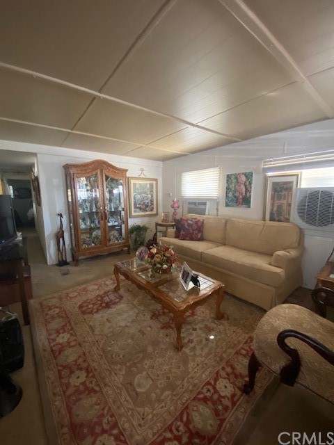 12874 California Street, Unit 48 Yucaipa, CA 92399 - Photo 9 of 21 a living room with furniture a lamp wooden floor and a large window