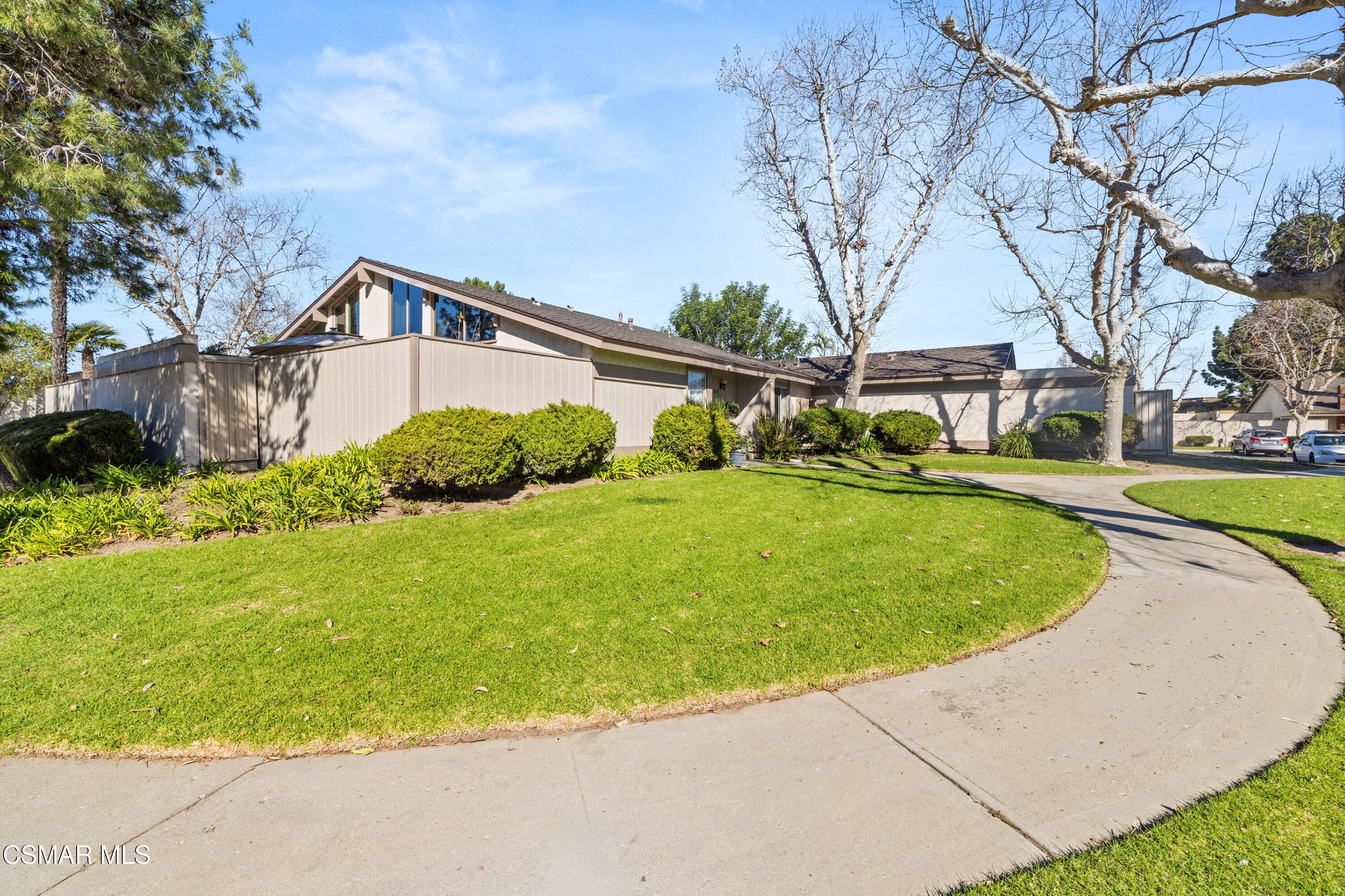 2225 Edelweiss Street, Unit 43 Oxnard, CA 93036 - Photo 2 of 26 a view of a house with a big yard plants and large trees