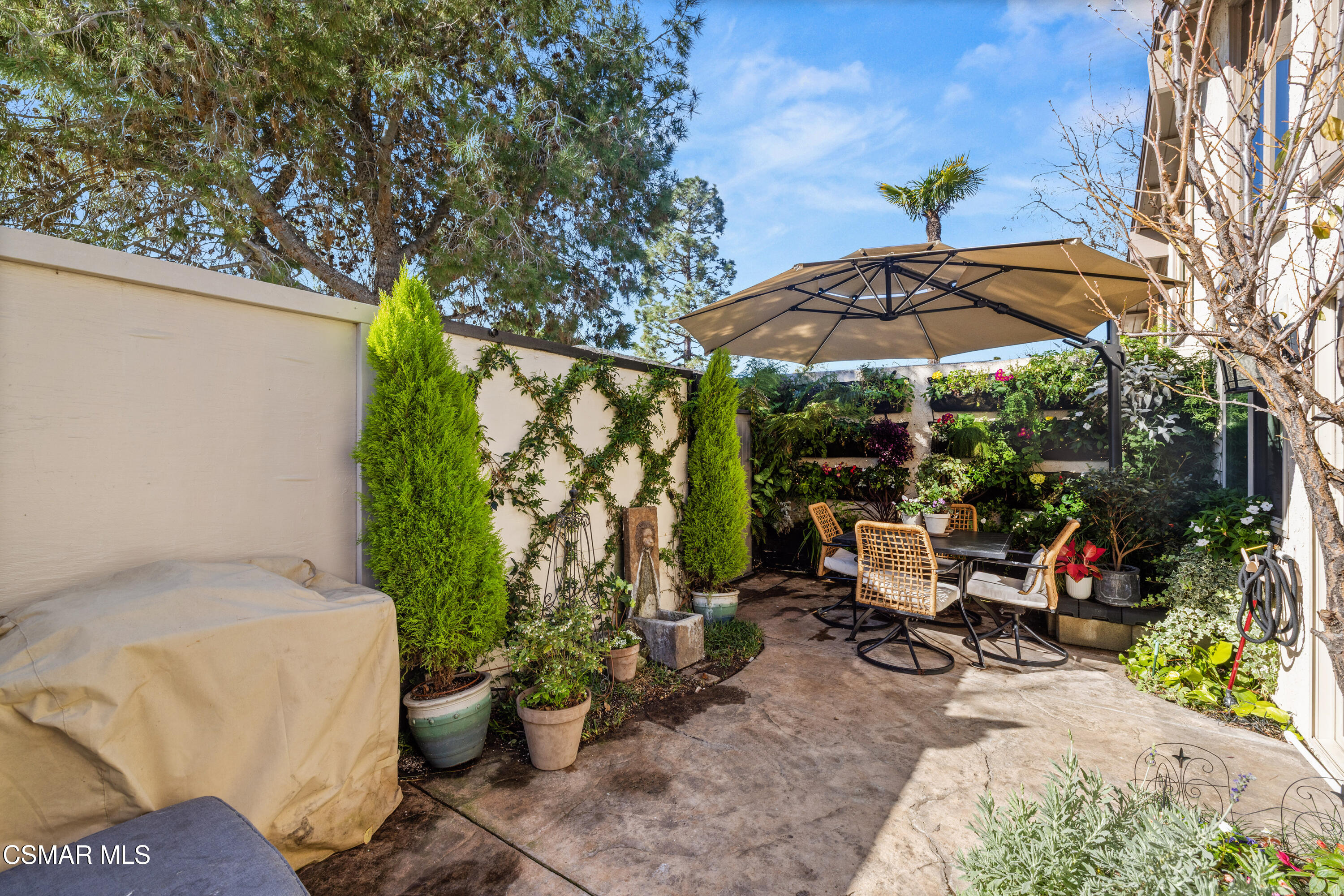2225 Edelweiss Street, Unit 43 Oxnard, CA 93036 - Photo 23 of 26 a view of a patio with table and chairs under an umbrella
