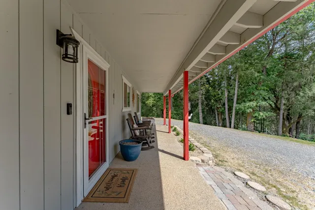 an outdoor sitting area with furniture and wooden floor