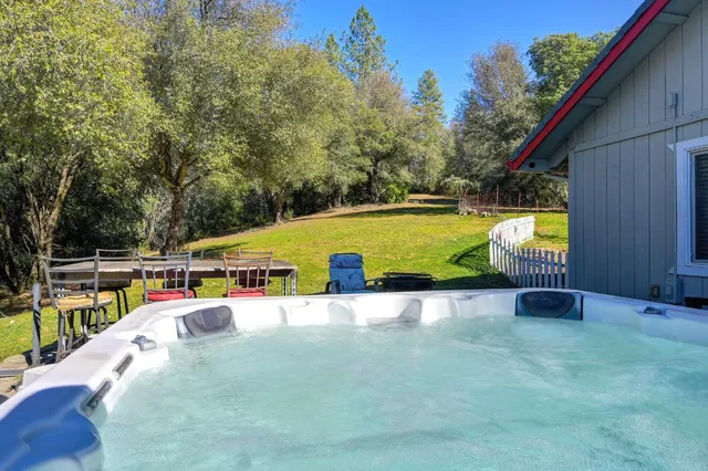 a view of a chairs and tables in the back yard of the house