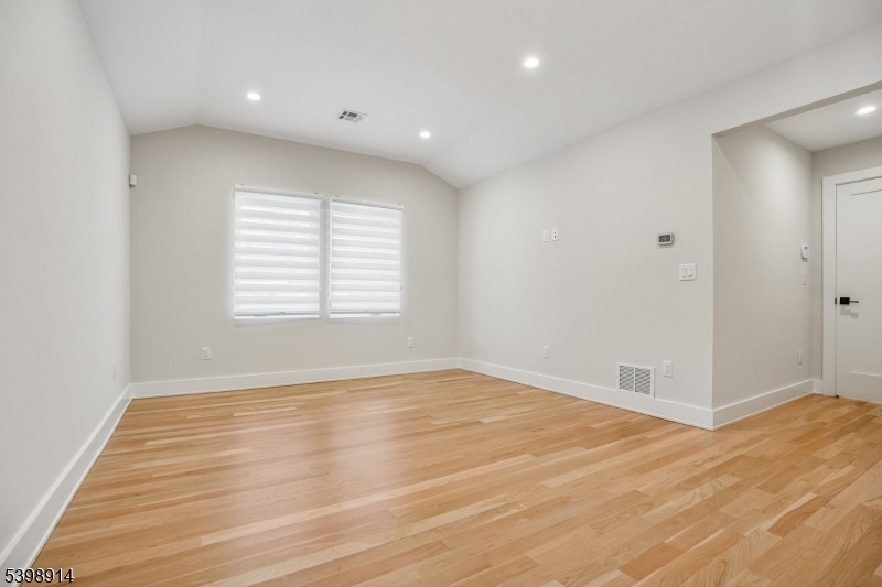 30 Hemlock Terrace Springfield, NJ 07081 - Photo 13 of 22 a view of an empty room with wooden floor and a window