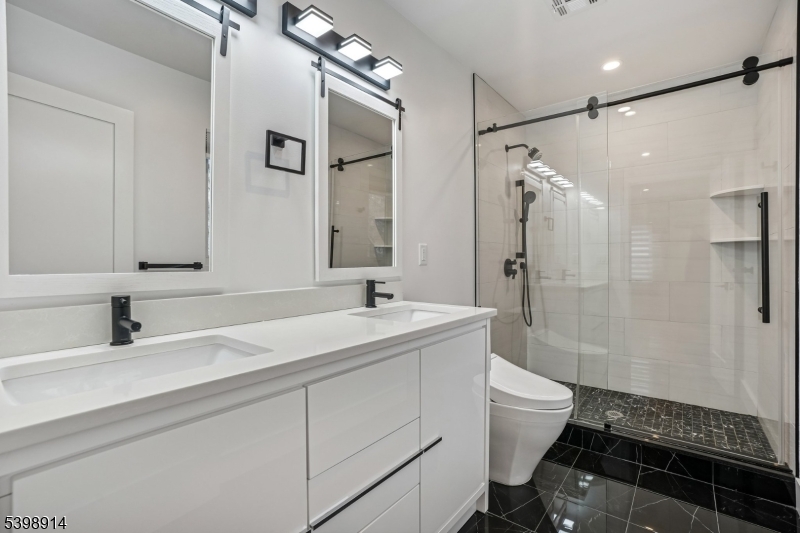 30 Hemlock Terrace Springfield, NJ 07081 - Photo 15 of 22 a bathroom with a double vanity sink toilet and shower