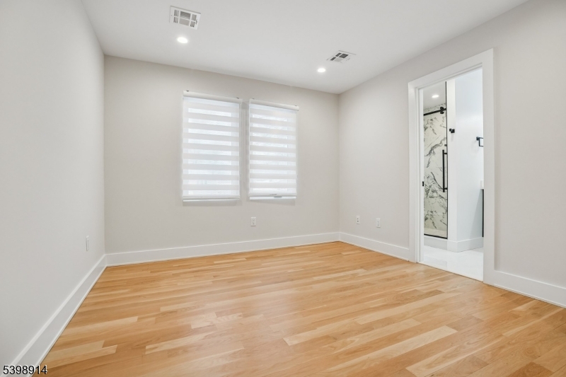 30 Hemlock Terrace Springfield, NJ 07081 - Photo 16 of 22 a view of an empty room with wooden floor and a window
