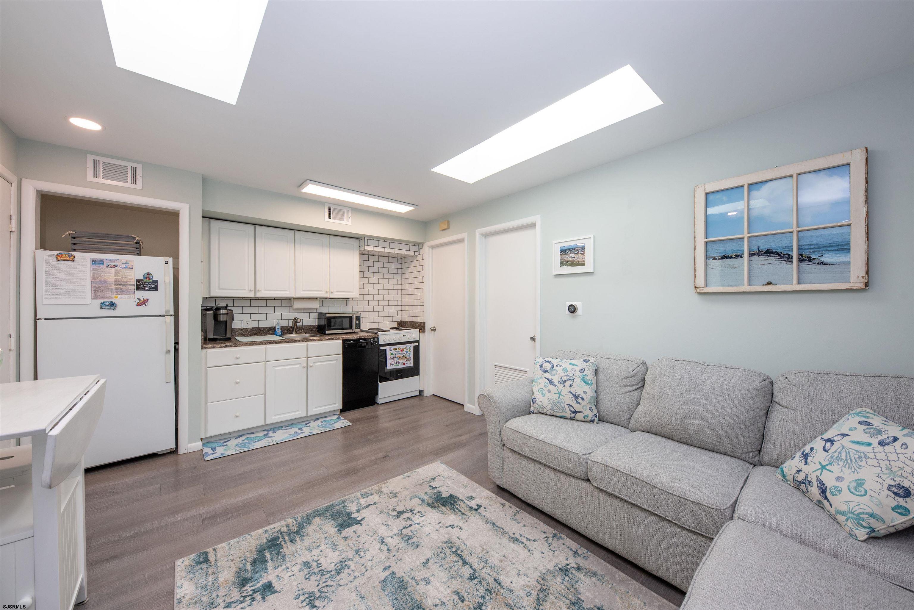 875 Plymouth Place, Unit 35 Ocean City, NJ 08226 - Photo 11 of 60 a living room with furniture and kitchen view