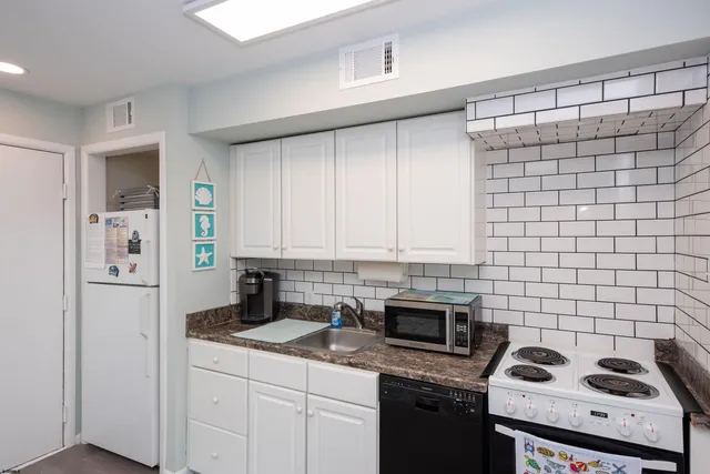 a bathroom with a sink and mirror with toilet