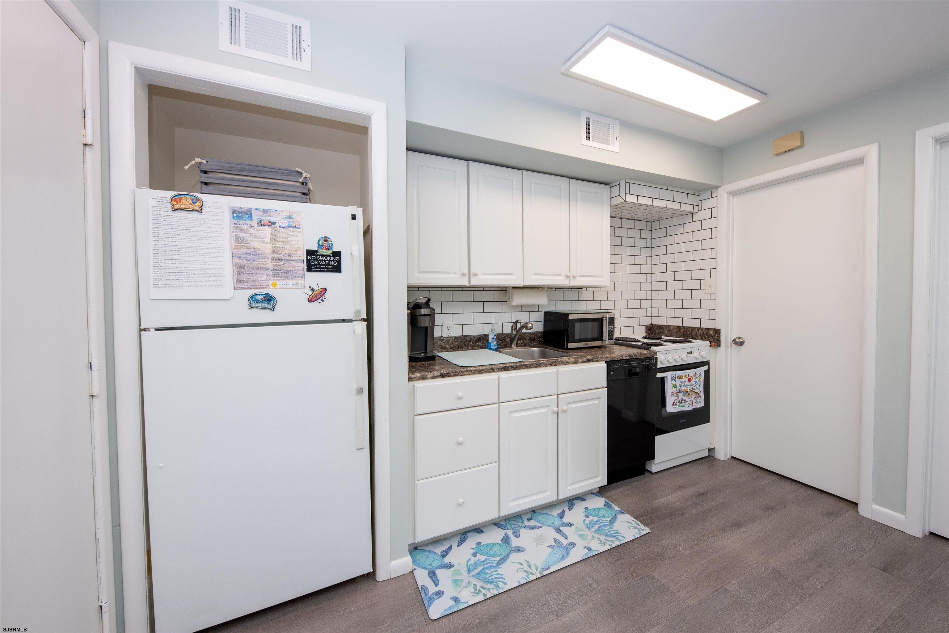 875 Plymouth Place, Unit 35 Ocean City, NJ 08226 - Photo 15 of 60 a kitchen with a refrigerator and white cabinets