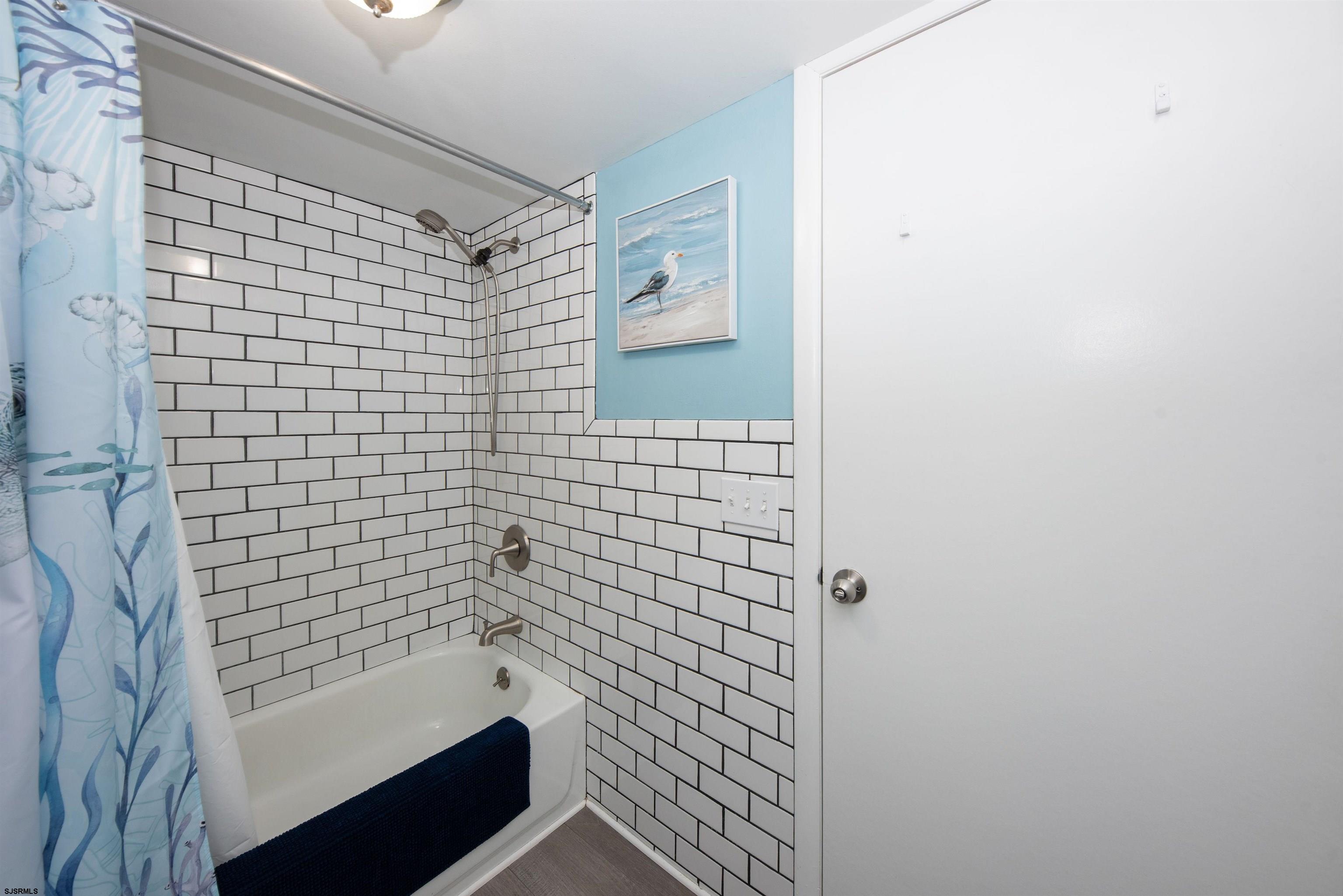 875 Plymouth Place, Unit 35 Ocean City, NJ 08226 - Photo 19 of 60 a bathroom with a shower and a bathtub