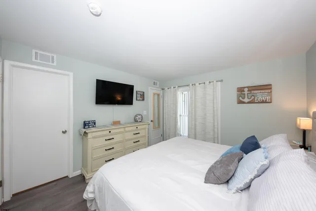 a bedroom with a bed and a night stand