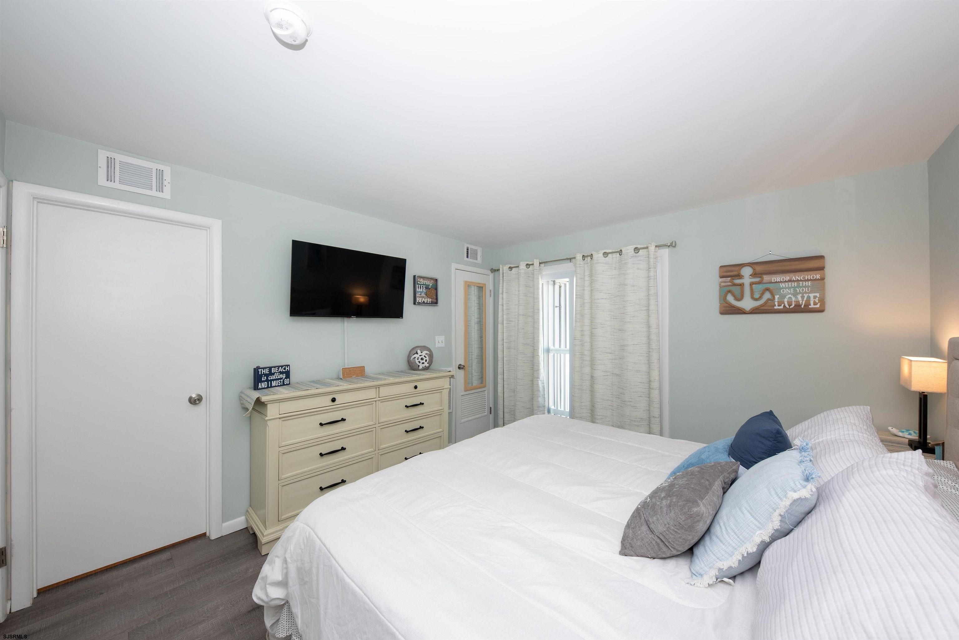 875 Plymouth Place, Unit 35 Ocean City, NJ 08226 - Photo 22 of 60 a bedroom with a bed and a flat screen tv