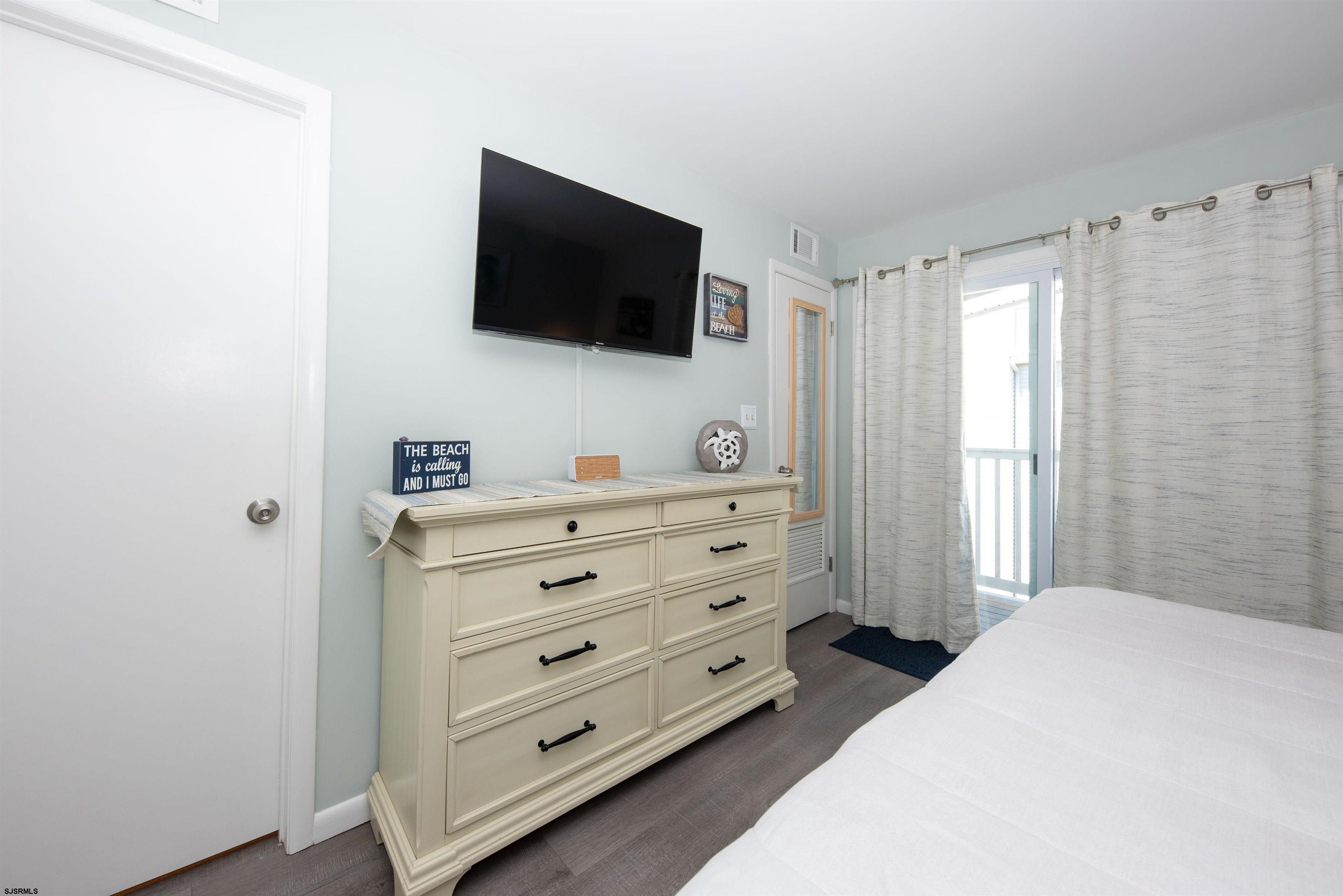 875 Plymouth Place, Unit 35 Ocean City, NJ 08226 - Photo 23 of 60 a bedroom with a bed and a flat screen tv