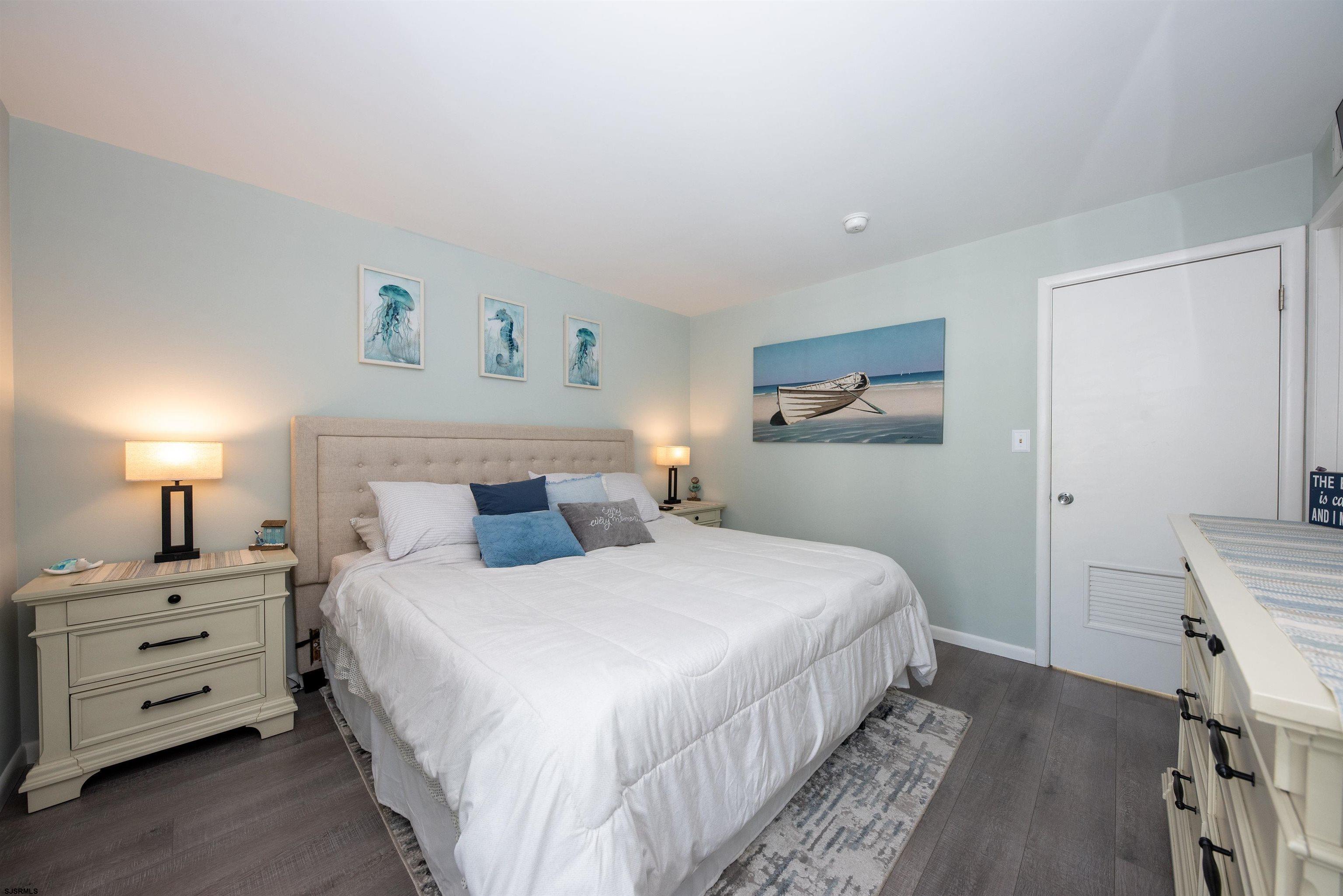 875 Plymouth Place, Unit 35 Ocean City, NJ 08226 - Photo 25 of 60 a bedroom with a bed and a night stand