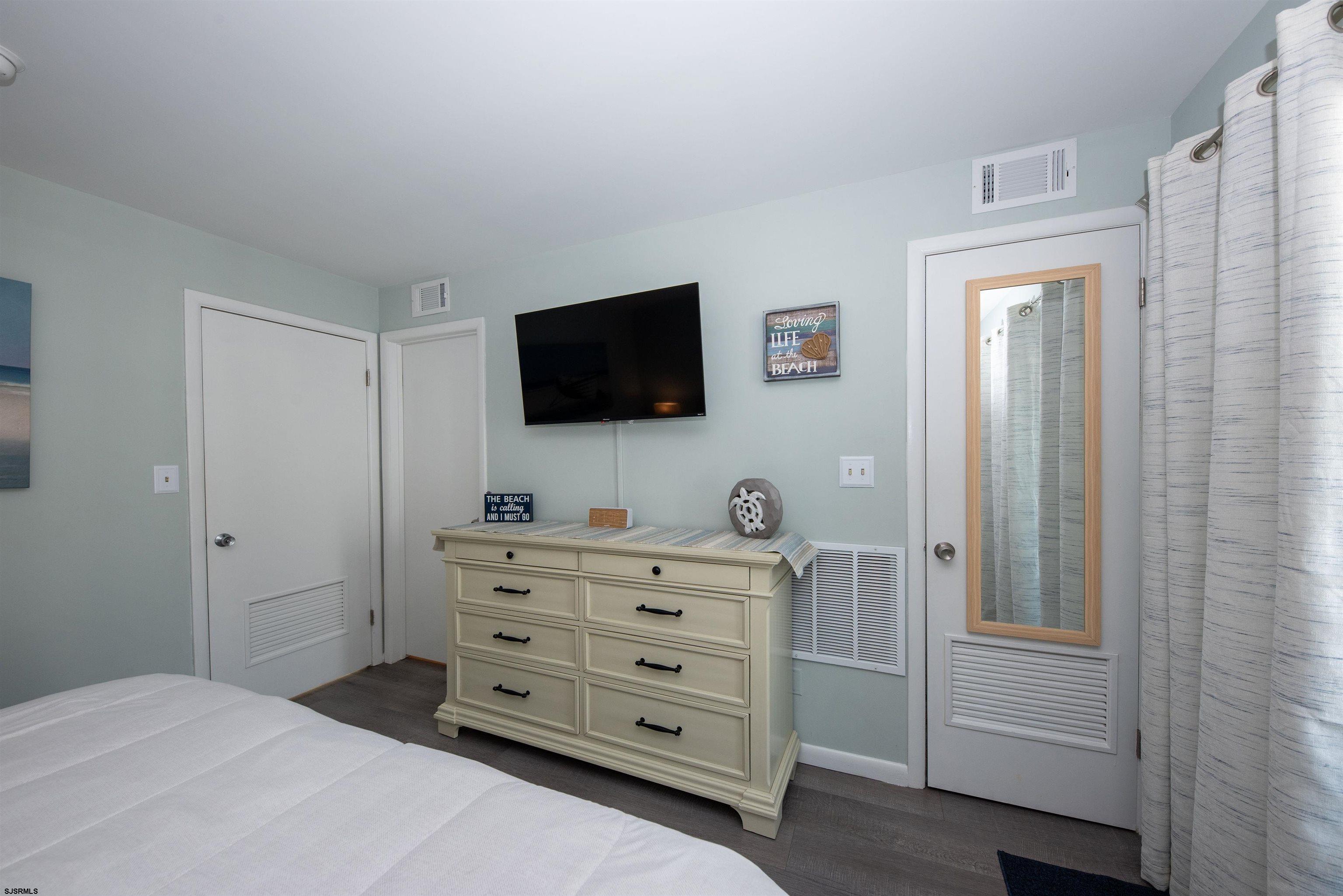 875 Plymouth Place, Unit 35 Ocean City, NJ 08226 - Photo 27 of 60 a room with a television and a dresser