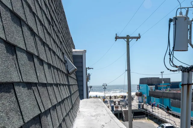 a terrace with outdoor seating and wooden floor
