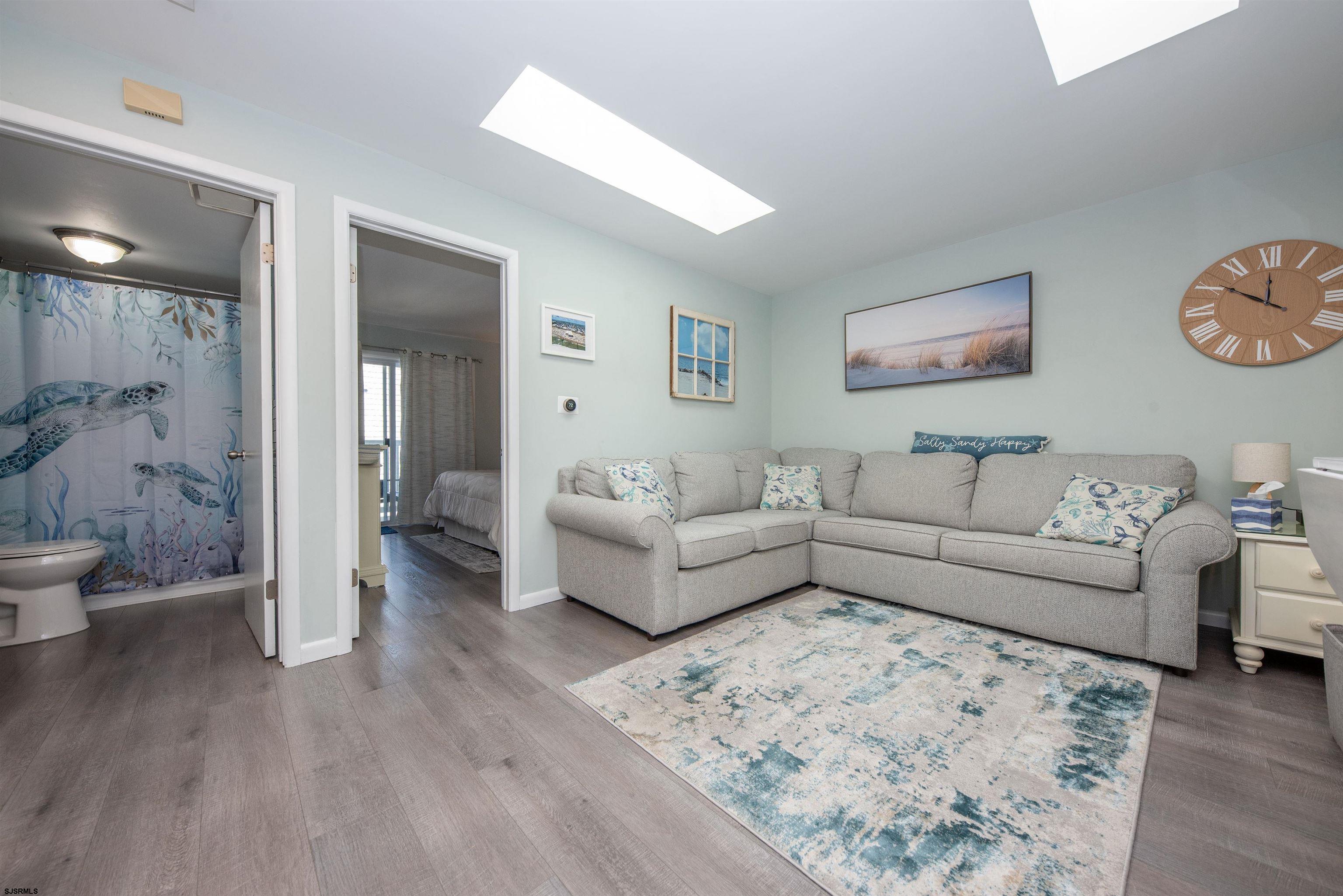 875 Plymouth Place, Unit 35 Ocean City, NJ 08226 - Photo 5 of 60 a living room with furniture and a wooden floor