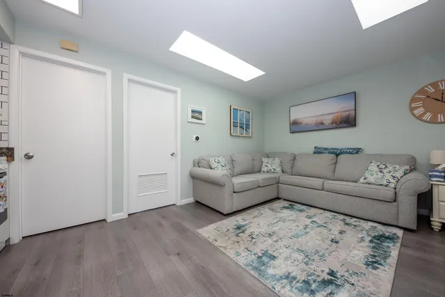 a view of a livingroom with furniture and a flat screen tv