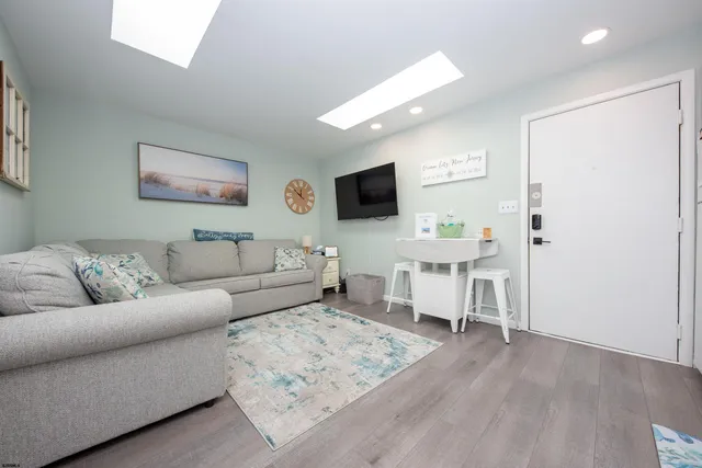a living room with furniture and kitchen