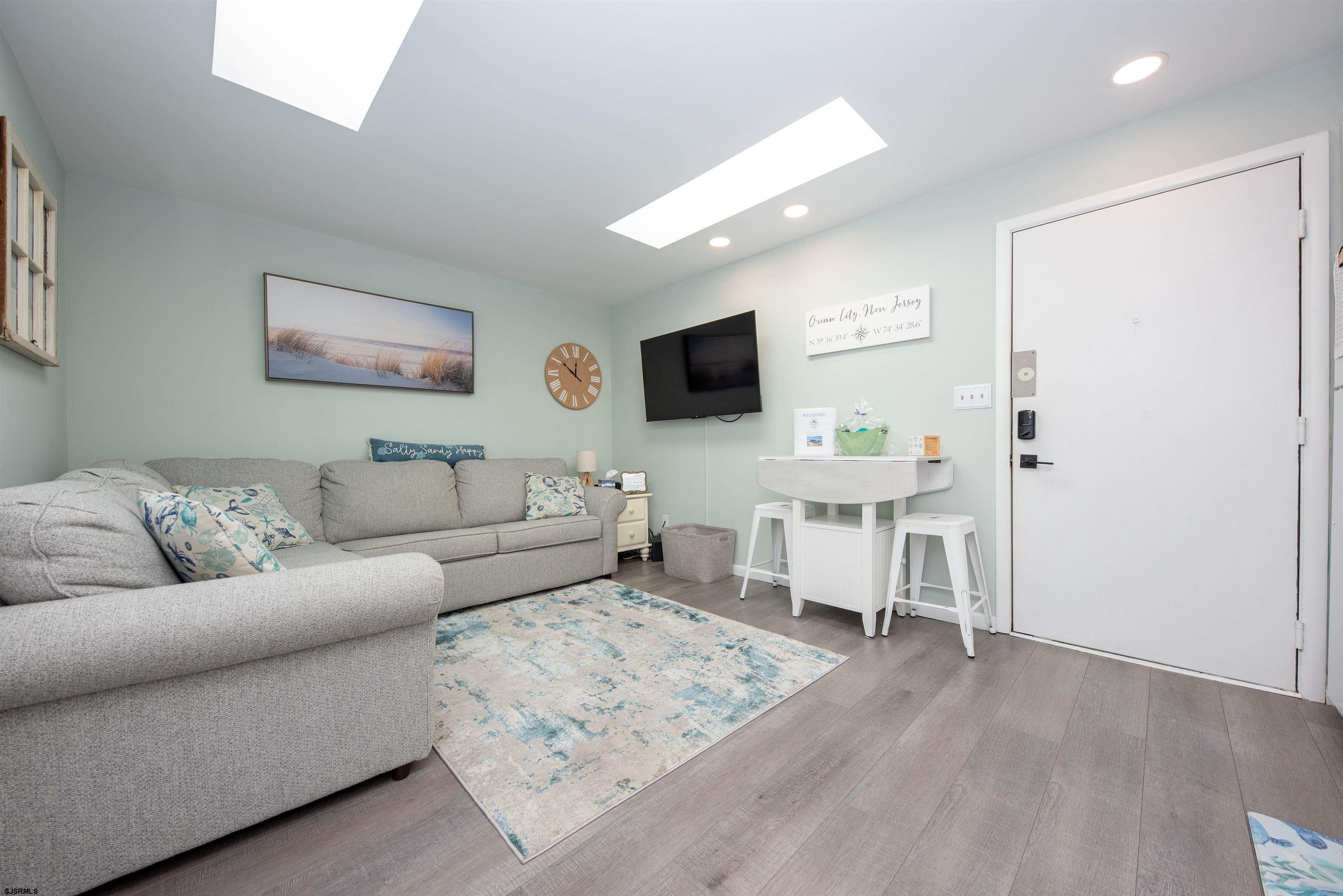 875 Plymouth Place, Unit 35 Ocean City, NJ 08226 - Photo 7 of 60 a living room with furniture and a flat screen tv