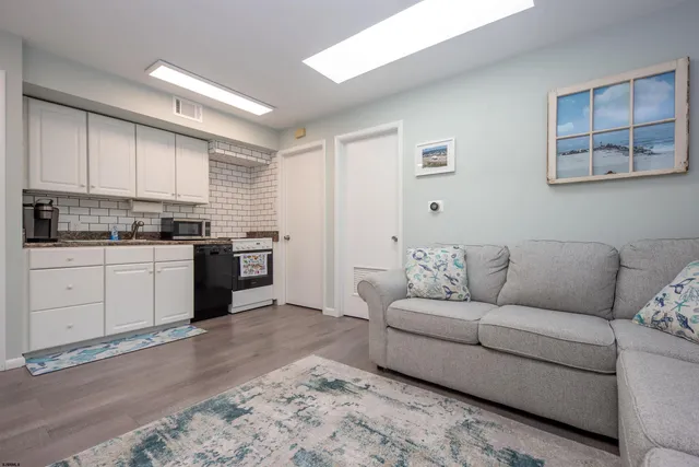a kitchen with a stove a sink and a refrigerator