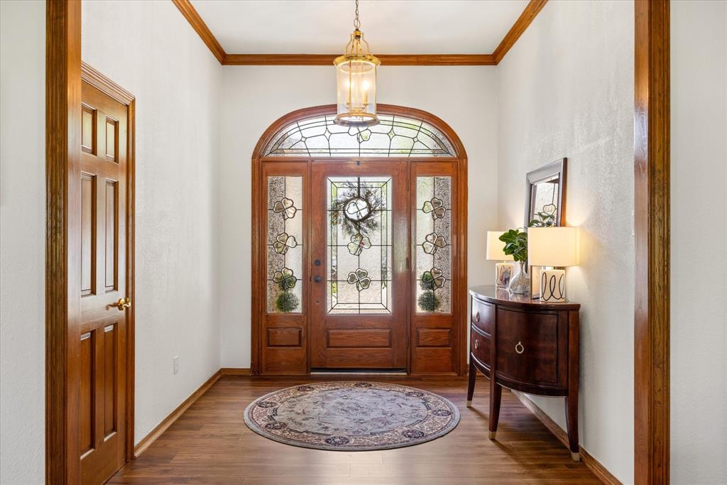 8911 Bontura Road Granbury, TX 76049 - Photo 2 of 39 Foyer entrance featuring crown molding and wood finished floors