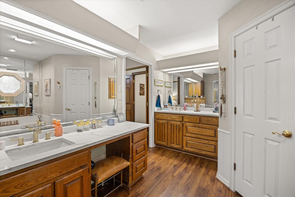 8911 Bontura Road Granbury, TX 76049 - Photo 26 of 39 Bathroom featuring two vanities and dark wood finished floors