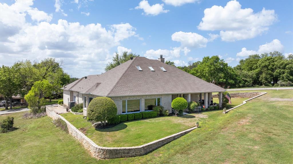8911 Bontura Road Granbury, TX 76049 - Photo 35 of 39 View of front of house featuring a front lawn, a shingled roof, and brick siding