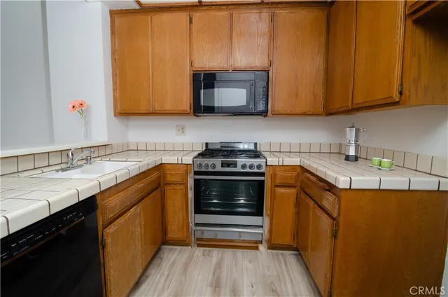 a utility room with wooden floor washer and dryer