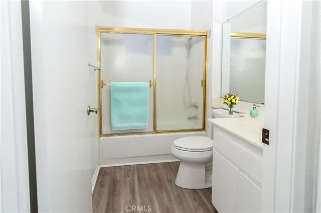 a bedroom with a bed a couch and a window