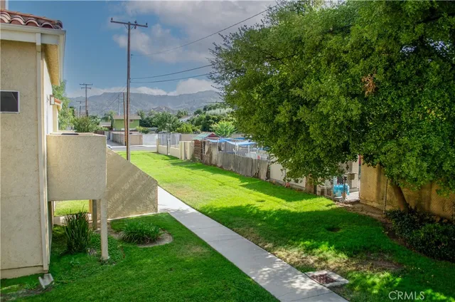 a view of a garden with a building in the background
