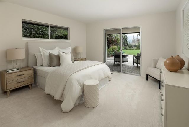 a bedroom with a bed and a couch