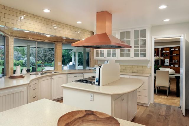 a kitchen with a sink a stove a table and chairs