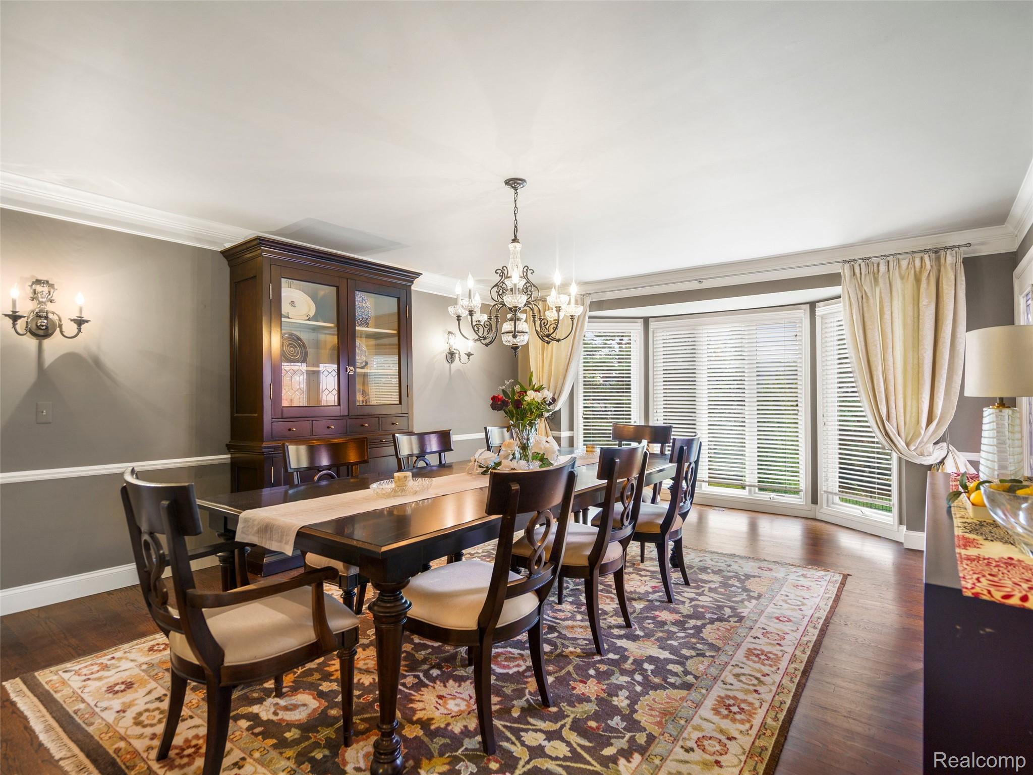 5724 Murfield Drive Rochester, MI 48306 - Photo 43 of 99 Dining room with a chandelier, ornamental molding, and dark wood finished floors