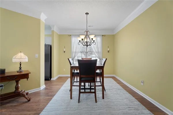 a dining room with furniture window and wooden floor