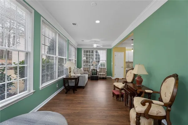 a living room with furniture and wooden floor