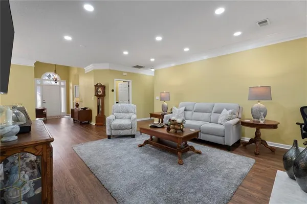 a living room with furniture and wooden floor