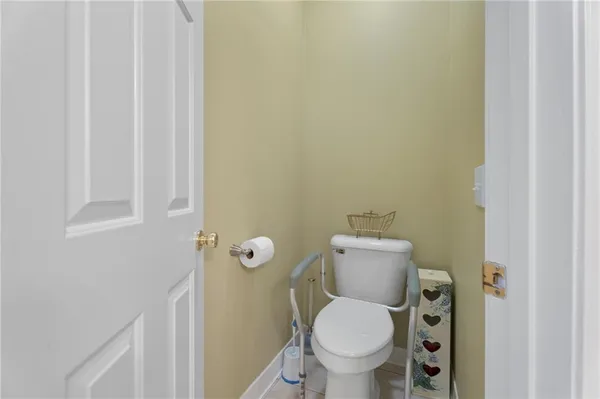 a white toilet sitting next to a shower