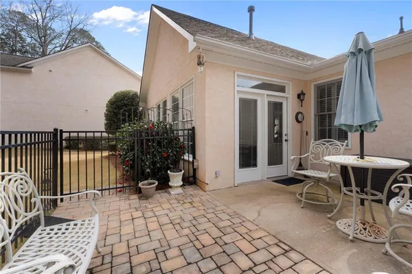 a view of a patio with table and chairs with wooden floor and fence