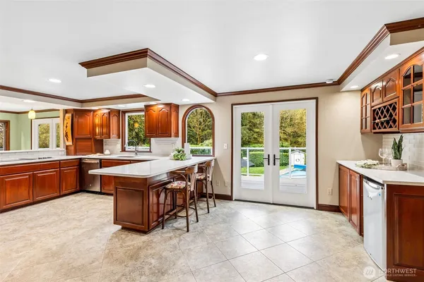 a kitchen with stainless steel appliances granite countertop a stove a sink and a refrigerator