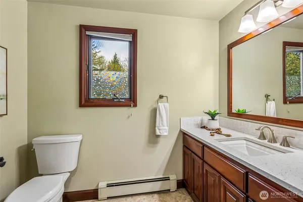 a bathroom with a toilet sink and mirror