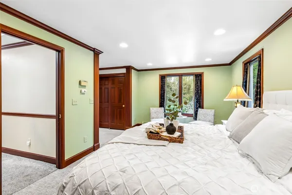 a bedroom with furniture and large window